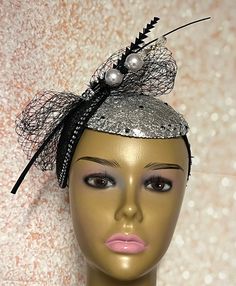 Looking for a head-turner? Look no further. This black and silver piece fits the criteria. Silver mesh fabric on sinamay base then trimmed with rhinestones and a hat pin. The hat pin may vary. Perfect for church and any other special occasions: tea parties, weddings, etc. Simple, yet chic. Length: approximately 9 inches Width: 5.5 inches (at the widest part) The hat pin may vary and is for decorative purposes only. The hat affixes to the head via a hat string. Handmade Gifts for mom, sister, wife, or yourself. PLEASE NOTE All items for Free Shipping will be shipped via USPS First Class Mail. Black Gatsby Style Fascinator For Evening, Black Gatsby Fascinator For Evening, Black Gatsby Style Fascinator, Black Hat Style Headpieces For Wedding, Black Hat Headpiece For Wedding, Black Hat-style Headpieces For Wedding, Gatsby Style Black Fascinator For Parties, Black Fitted Fascinator For Party, Fitted Black Fascinator For Party