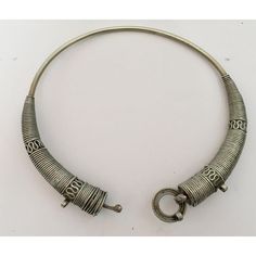 Traditional torque or Hansuli silvered necklace choker from Lambadi or Banjara and Sugali People, Andhra Pradesh, India.t India, circa 1940. Fabulous vintage heavy spiral silvered plated choker necklace in wonderful vintage condition. Silver, but not of the standard of sterling. Spirals of thick silver wire develop in three sections to the left and to the right. On one side of the bridge is a loop, on the other a screw fitting. This sculptural and coiled choker looks truly amazing on any neck or Ceremonial Silver Metal Choker, Antique Silver Metal Choker, Traditional Spiral Silver Jewelry, Traditional Silver Spiral Jewelry, Traditional Spiral Metal Jewelry, Silver Vintage Choker With Intricate Design, Vintage Silver Choker With Intricate Design, Heavy Vintage Choker Jewelry, Heavy Vintage Choker Necklaces