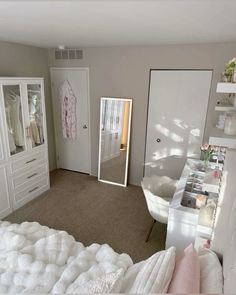 a bedroom with a bed, dresser and mirror