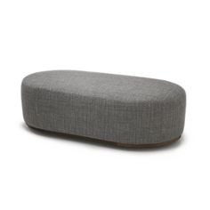 a grey ottoman sitting on top of a white floor