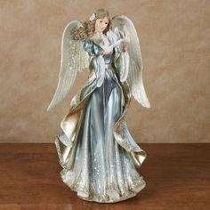 an angel figurine sitting on top of a wooden table