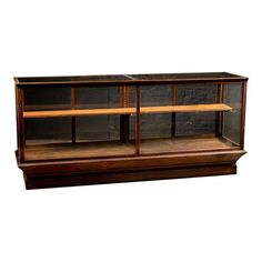 an old wooden display case with glass doors on the top and bottom shelf, in front of a white background