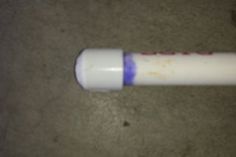 a white and blue toothbrush laying on the ground