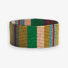 a multicolored bracelet on a white background with an orange, yellow and green stripe