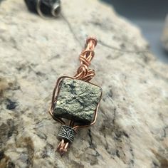 Raw Iron Pyrite Gemstone Pendant - Copper Wire Wrapped, Handmade Energy Stone Necklace, Unique Protective Talisman, Mens Jewelry  Raw Iron Pyrite cube wire wrapped in a braid using copper wire. one of my favorite pieces.  Pyrite is a stone of protection and intellect, enhancing mental clarity and shielding from negative energies.  This handcrafted piece is a beacon of empowerment, designed to accompany you on your journey to success. Protective Talisman, Cube Pendant, Iron Pyrite, Energy Stones, Necklace Unique, Mental Clarity, Stone Necklace, Copper Wire, Gemstone Pendant