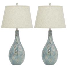 two blue vases with white lamps on each one and a linen shade on the other