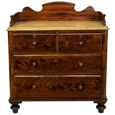 an old wooden dresser with marble top