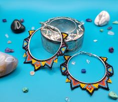 beaded hoops and earrings on a blue background