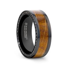 the black ceramic ring with wood inlays and diamonds is shown on a white background