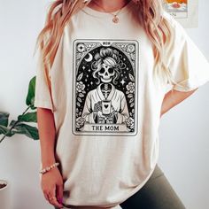 The Mom Tarot Card Shirt, Skeleton Mother T-Shirt. Product Description * Material: This T-Shirt Is Crafted From 100% Open-End Cotton, Ensuring Comfort And Durability. * Sizes: Available In A Range From S To 3xl, Finding Your Perfect Fit Is Easy. Check Out Our Comprehensive Sizing Chart In The Product Photos To Ensure The Ideal Size For You. Double-Check Your Selection Before Completing Your Purchase To Avoid Any Sizing Issues. * Processing: Your Order Will Be Securely Processed And Shipped Withi White Graphic Tee With Skull Print, White Skull Print Graphic Tee, Shirts For Grandma, Mom Fits, Tarot Card Shirt, Silhouette Tutorials, Skeleton Shirt, Mom Tees, Christmas Day