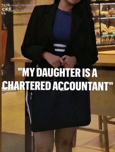 a woman standing in front of a counter with a sign that says, my daughter is a chartered account