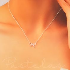 This dainty and adjustable necklace is the perfect gift for her, a timeless expression of love and appreciation.  Charming and cute, our Dainty Sterling Silver Bow Necklace features a beautiful silver bow pendant on a delicate silver chain.  Sterling Silver is hypoallergenic and Nickel free so no skin irritation or allergies. It is also very durable to last for years to come. Silver jewellery can be adapted to any look, any style, and any occasion. Like a well-established neutral, silver jewelle Feminine Jewelry For Bridesmaid Gift, Feminine Sterling Silver Necklace With Clavicle Chain, Feminine Sterling Silver Clavicle Chain Necklace, Feminine Sterling Silver Choker Necklace, Feminine Charm Necklaces For Wedding, Feminine Wedding Charm Necklace, Elegant Bridesmaid Gift Necklace, Delicate Silver Charm Necklaces For Gift, Delicate Adjustable Chain Necklace For Gift