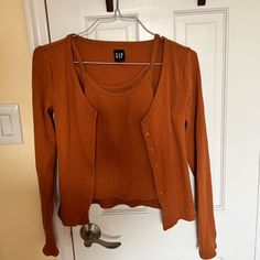 Gap Cardigan And Cami Set. Really Pretty Burnt Orange Color. Both Size Mediumcardigan Is M Tall. Nwot Gap Everyday Tops For Fall, Gap Everyday Fall Tops, Gap Tops For Everyday Fall Wear, Everyday Gap Tops For Fall, Gap Casual Spring Sweater, Gap Fitted Tops For Fall, Trendy Long Sleeve Tops From Gap, Trendy Long Sleeve Tops By Gap, Trendy Long Sleeve Gap Tops