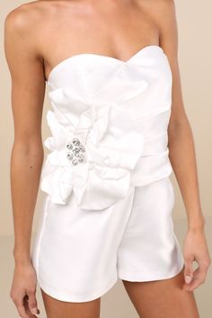 Make a statement in luxe style with the Lulus Feeling Incredible White Taffeta Applique Strapless Romper! Sleek woven taffeta shapes a sweetheart neckline (with hidden no-slip strips) and a strapless, pleated bodice with supportive side boning and an oversized, floral-like three-dimensional applique with sparkling rhinestone accents at the center. Fitted waist sits atop relaxed shorts. Hidden back zipper/clasp. Fit: This garment fits true to size. Length: Above mid-thigh. Size medium measures 24 Dimensional Applique, 3d Applique, Rehearsal Dinner Dresses, Luxe Style, Strapless Romper, Adhesive Bra, White Romper, Pleated Bodice, Dinner Dress