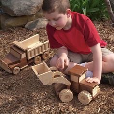 a young boy playing with wooden toys on the ground