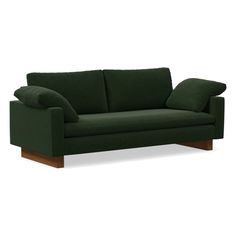 a green couch with two pillows on the back and one arm folded out to show it's shape