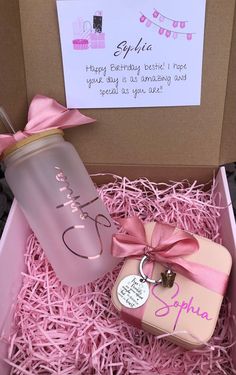 a pink gift box containing a personalized baby bottle