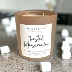 a candle with marshmallows scattered around it