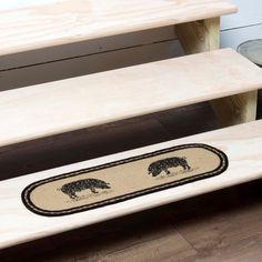 two wooden benches with bears on them sitting next to each other