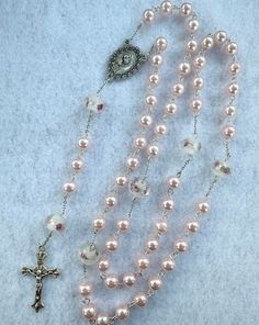 A full size rosary made with pink pearl beads and glass floral beads. Cross Necklaces, Diamond Cross Necklaces, Diamond Cross, Pink Pearl, Rosary, Pearl Beads, Bead Charms, Cross Necklace, Beauty Book