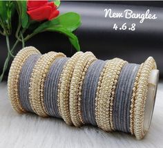 Indian jewellery Gold plated thread and pearl bangles set in grey Grey Bangles Set, Indian Jewellery Gold, Pearl Bangles, Handbag Essentials, Bangles Set, Thread Bangles, Pearl Bangle, Jewellery Gold, Gold Jewelry Indian