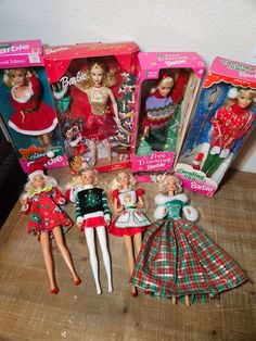 several barbie dolls are shown in their christmas outfits and clothes on the table next to each other