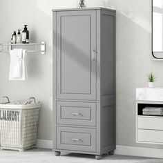 a bathroom with a gray cabinet next to a white sink