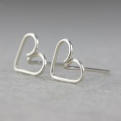 "This unique heart stud earrings are handmade wire wrapped sterling silver. Free US shipping Customers who purchased this item said: \"Very nice. Glad I bought them\" The heart is the ultimate symbol of love. This heart earrings are a perfect gift for the one you love, or for bridesmaid gift, or for birthday gift. We also can customize design for you. The dimension of the earrings is 9mm/3/8inches. ;-) My contact number: 626-379-1904. Please contact me if you would like to order multiples or cus Dainty Earrings For Valentine's Day Gift, Delicate Sterling Silver Earrings For Mother's Day, Cute Silver Earrings For Anniversary, Minimalist Heart Earrings As Gift, Minimalist Heart Earrings With Ear Wire As Gift, Minimalist Earrings For Mother's Day Gift, Minimalist Sterling Silver Heart Earrings For Wedding, Silver Earrings For Mother's Day Anniversary Gift, Sterling Silver Earrings For Anniversary