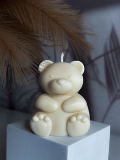 a white bear candle sitting on top of a block