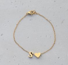 Gold Heart Initial Bracelet | Custom Letter Bracelet | Dainty Initial Bracelet | Gold Personalized Name Bracelet | Name Bracelet. Material: 14K Gold Filled Closure: Lobster Claw Necklace Length: 4.5 Inch to 9 Inch (We can make it to any length of your choice)  *These necklaces are WATERPROOF *Nickel and Lead-free. *Non-Tarnish Gold Necklace Packaging: Comes in a gift bag, ready to be gifted to the special one. **Please use personalization category to add your initial. Initial Bracelet Gold, Bracelet Name, Bracelet Packaging, Claw Necklace, Necklace Packaging, Armband Gold, Bracelet Initial, The Special One, Gold Armband