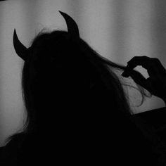 the silhouette of a woman with horns on her head