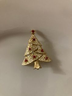 "Christmas tree brooch with red crystals. In good vintage condition.  Measures  1 11/32\" by 1 23/32\"" Gold Christmas Holiday Brooch, Vintage Red Brooches For Festive Occasion, Vintage Red Jewelry For Holidays, Red Vintage Jewelry For Holidays, Red Vintage Holiday Jewelry, Red Christmas Brooch For The Holidays, Red Christmas Brooch For Holidays, Holiday Red Brooch Jewelry, Red Christmas Holiday Brooch