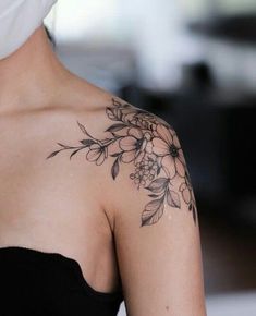 a woman with a flower tattoo on her shoulder