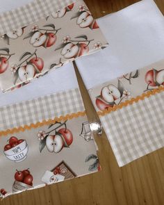 four pieces of cloth with apples on them