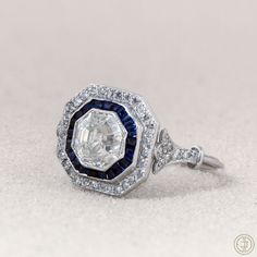 an image of a ring with diamonds and blue sapphires