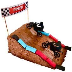 a cake shaped like a dirt bike race track