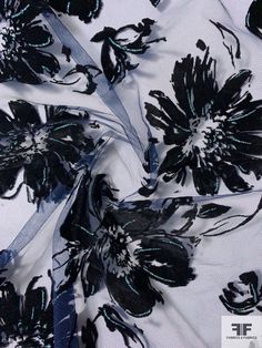 black flowers on white fabric with blue trim