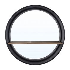 a round mirror with a wooden shelf in the middle and an oval window behind it