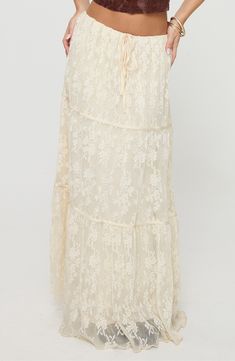 Full of romantic charm, this sweeping tiered maxi skirt is crafted from delicate lace with a lettuce hem. 38 1/2" length (size 4) Ties at waist Lined 100% polyester Hand wash, line dry Imported Beige Lace Skirt With Lace Patchwork, Delicate Lace Skirt For Spring, Lace Tiered Skirt Bottoms With Lace Patchwork, Flowy Tiered Maxi Skirt In Cream, Cream Flowy Tiered Maxi Skirt, Summer Lace Maxi Skirt, Beige Flowy Lace Skirt, Beige Lace Long Skirt, Summer Lace Maxi Skirt With Ruffled Detail