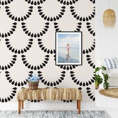 a living room with black and white wallpaper, a bench and pictures on the wall