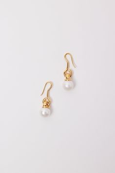 The Gold Long Pearl Earrings unite sculptural elements and natural treasures to form a timeless, yet radical pair of earrings. Sapir Bachar's collection is handcrafted locally in Tel Aviv and designed to be subtly seductive and timeless, embodying the essence of the new ancient. Made from 24K gold plated sterling silver and freshwater pearls. Modern Pearl Drop Earrings For Everyday Elegance, Luxury Round Earrings For Everyday Elegance, Elegant Earrings With Ear Wire For Everyday Elegance, Timeless Single Earring For Everyday Elegance, Elegant Everyday Earrings With Ear Wire, Refined Pearl Drop Earrings As Gift, Refined Pearl Drop Earrings For Gift, Timeless Elegant Drop Earrings, Elegant Yellow Gold Earrings With French Hook