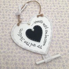 a white and black heart hanging on a wall