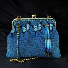 Introducing our 100% handmade blue clutch, which is crafted with care using crochet techniques and features beads that are tightly woven into the fabric with durable nylon thread. This unique feature sets our crochet pouch apart from embroidered handbags. Our blue beaded evening bag are soft, cool to the touch, and come with beautiful decorative tassels. This beaded clutch is one-of-a-kind and takes 4-5 weeks to create. We take pride in our collection of unique handbags that are designed to comp Blue Bohemian Pouch Clutch, Blue Handmade Evening Bag For Everyday Use, Handmade Blue Rectangular Evening Bag, Handmade Blue Rectangular Pouch, Handwoven Clutch Pouch For Gifts, Handwoven Clutch Pouch As A Gift, Handmade Blue Clutch For Evening, Handmade Blue Clutch For Party, Blue Bohemian Clutch Handmade