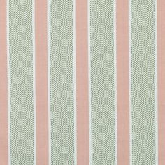 a pink and green striped wallpaper with small white dots on the top of it