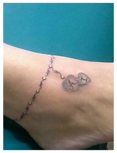 a person with a tattoo on their foot that has an elephant and hearts drawn on it