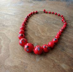 "Vintage glass bead necklace/choker, glass beads are descending in size and are hand knotted between each. Each bead has colorful striped \"balls\" on them that look like little sea urchins. Circa 1940's - 50's (possibly earlier), marked Japan on hook clasp. Largest bead is approx. 3/4\". Necklace is in good condition, please see photos. Offbeat Avenue uses recycled packaging when available." Vintage Czech Glass Beaded Necklaces With Polished Beads, Vintage Czech Glass Beaded Necklaces With Round Beads, Vintage Czech Glass Beaded Necklace With Round Beads, Vintage Czech Glass Beaded Necklace, Vintage Style Czech Glass Beaded Necklace, Retro Large Beads For Gifts, Vintage Beaded Necklaces With Colorful Beads, Vintage Glass Beaded Necklaces With Colorful Beads, Vintage Glass Beaded Necklaces For Jewelry Making