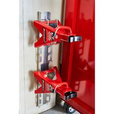 a red shelf with two metal brackets attached to it