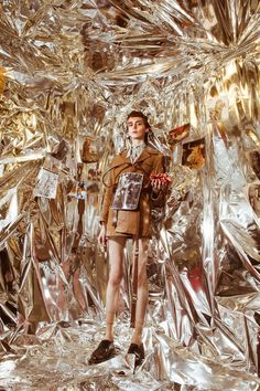 a man standing in front of a metal wall with lots of tin foil on it