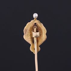 During the turn of the nineteenth century, artisans were inspired by the changing roles of women in society and began depicting the free flowing feminine form in brooches, bracelets, rings and more. This antique stickpin (circa 1890-1900) features a woman of 14k gold, adorned in enamel with a single diamond crown and a pearl accent. The pin head measures 0.9 inches by 0.5 inches wide with the entire pin measuring 1.9 inches long. It is in very good condition; however there is a chip to the ename Victorian Brooches For Ceremonial Occasions, Art Nouveau Brooch For Formal Occasions, Art Nouveau Formal Jewelry Brooch, Victorian Style Ceremonial Yellow Gold Brooches, Vintage Ceremonial Jewelry With Screw Back, Antique Wedding Lapel Pin, Antique Gold Art Nouveau Jewelry For Formal Occasions, Antique Style Pins As Gifts, Women In Society