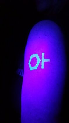 a person with a purple light on their arm that has the word o + written on it